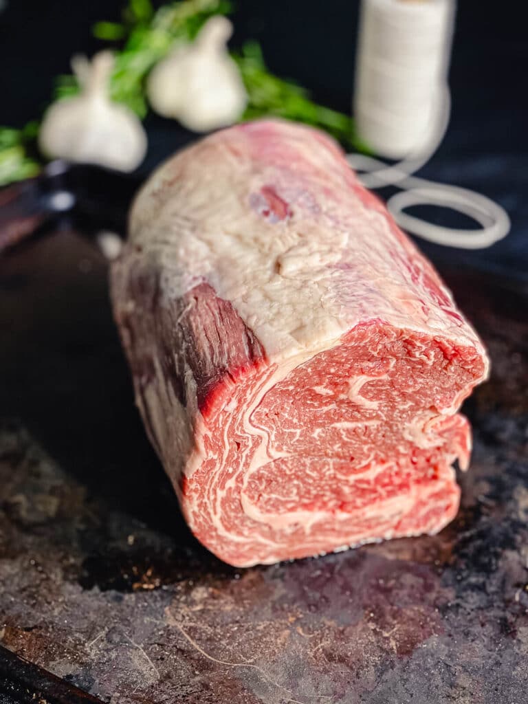 boneless prime rib tied into a cylinder shape with butcher's twine