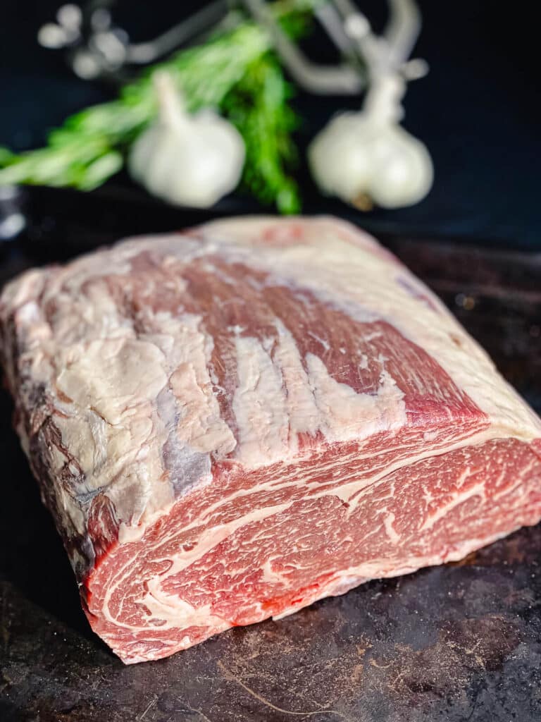 boneless prime rib sitting on cooking tray