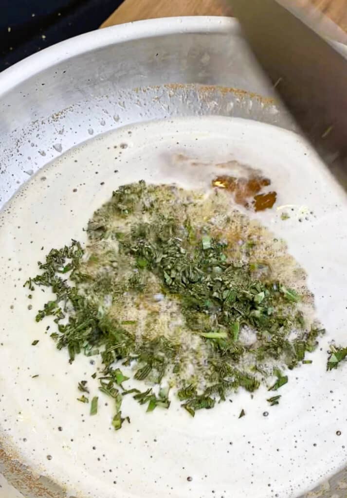 sage added to brown butter in a pan