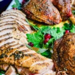 roasted turkey with parsley sitting on a platter