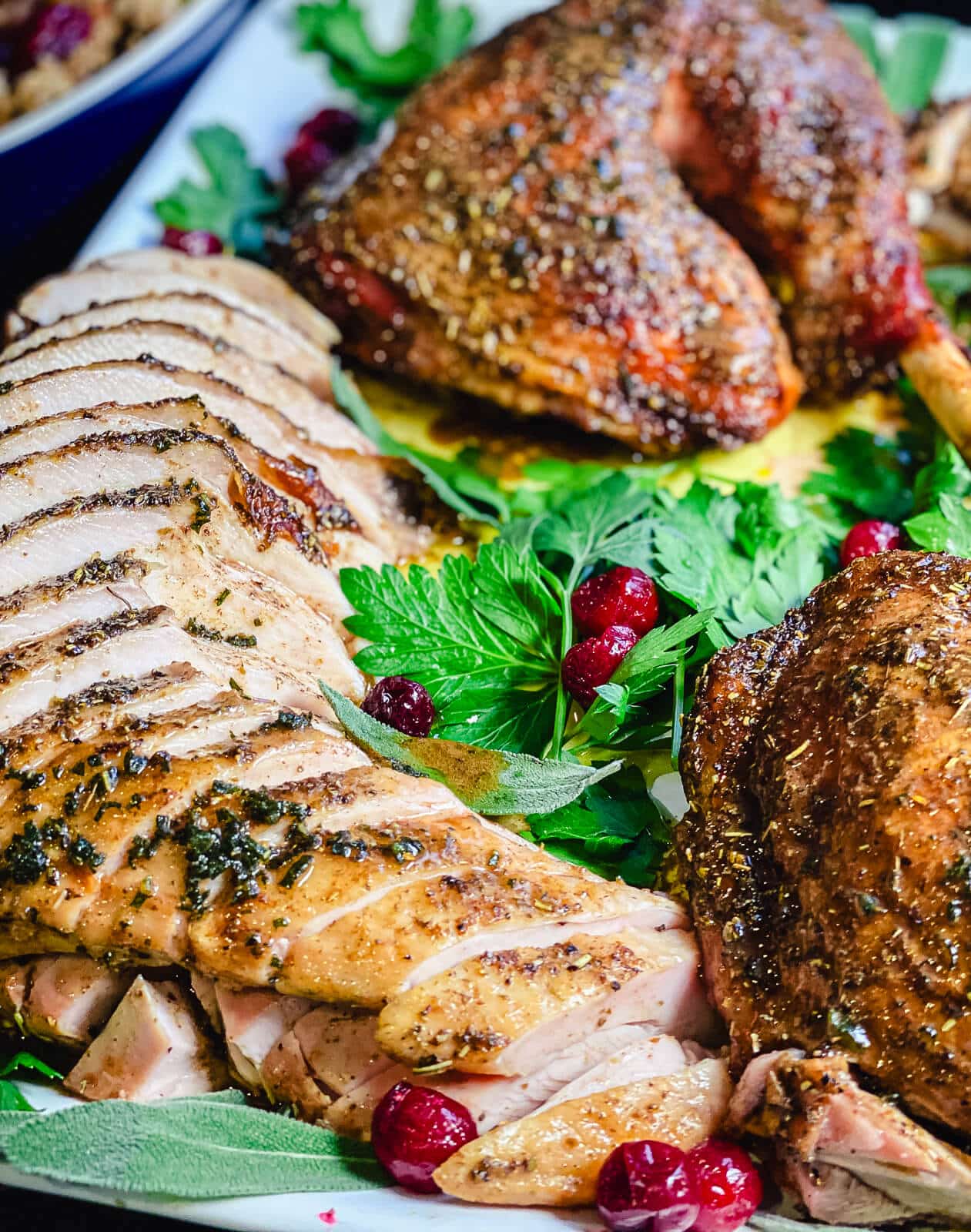 roasted turkey with parsley sitting on a platter
