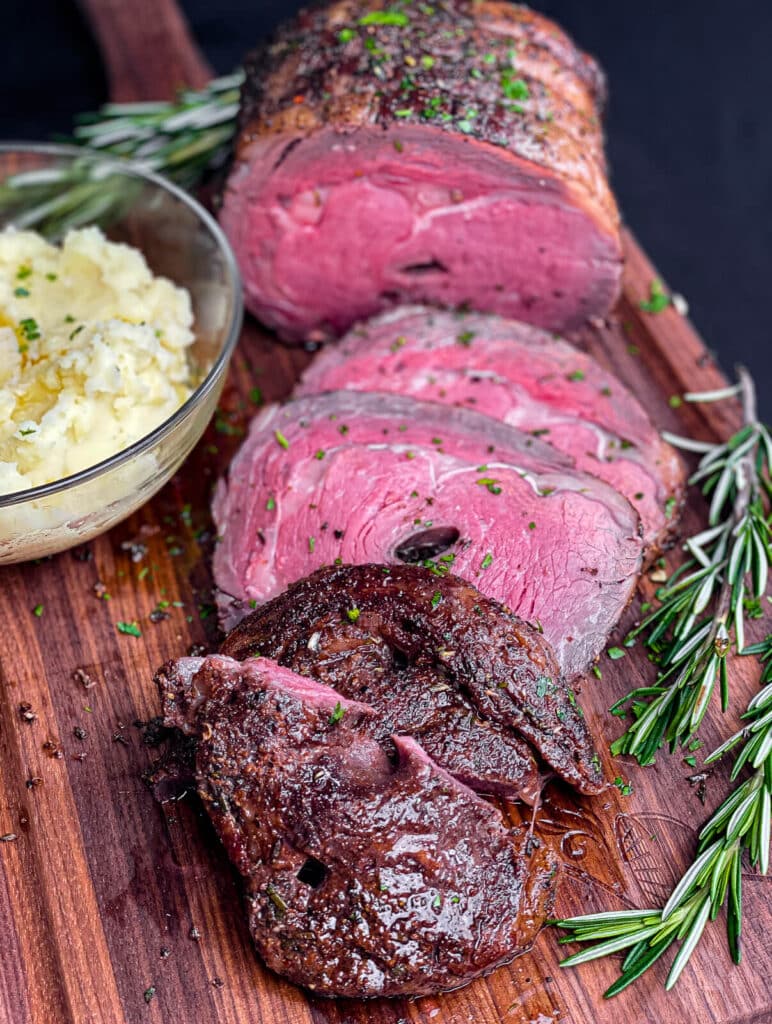 sliced prime rib roast on a cutting board