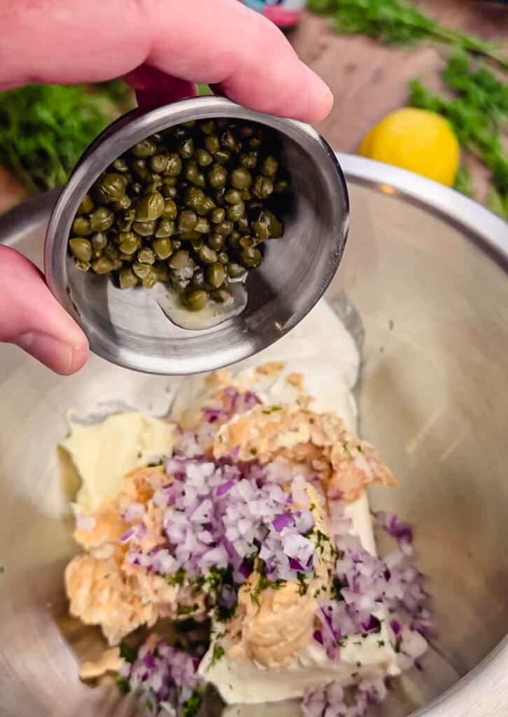 ingredients for smoked salmon dip being added to a bowl