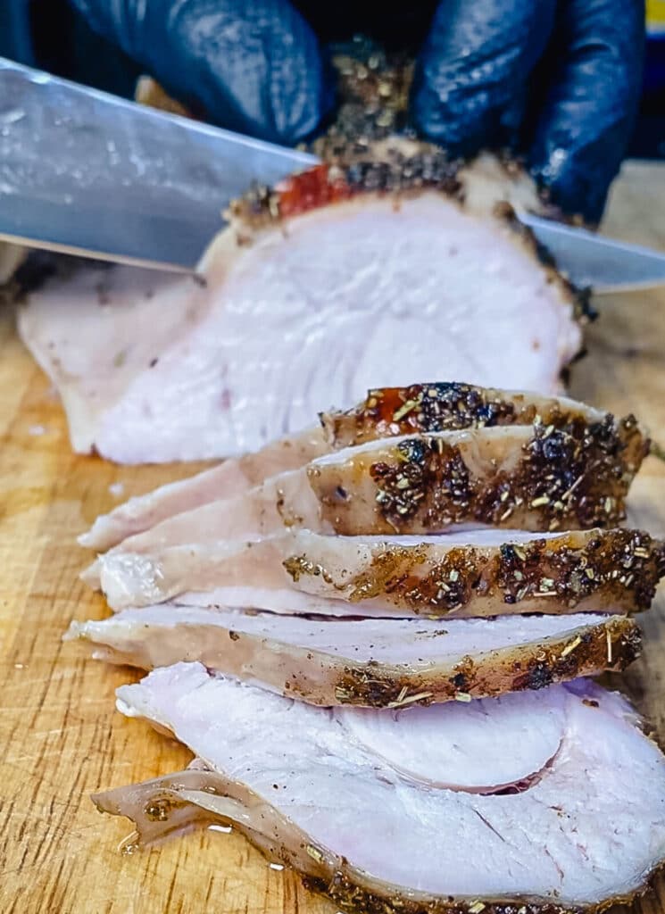 slicing a roasted turkey breast with a knife