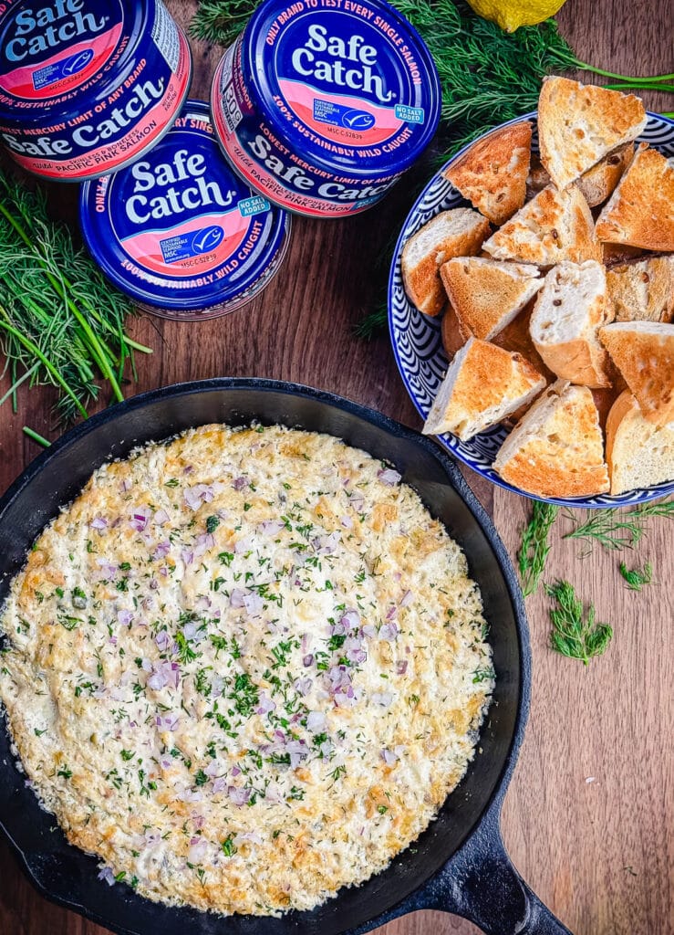 smoked salmon dip in a cast iron pan with bagel bites