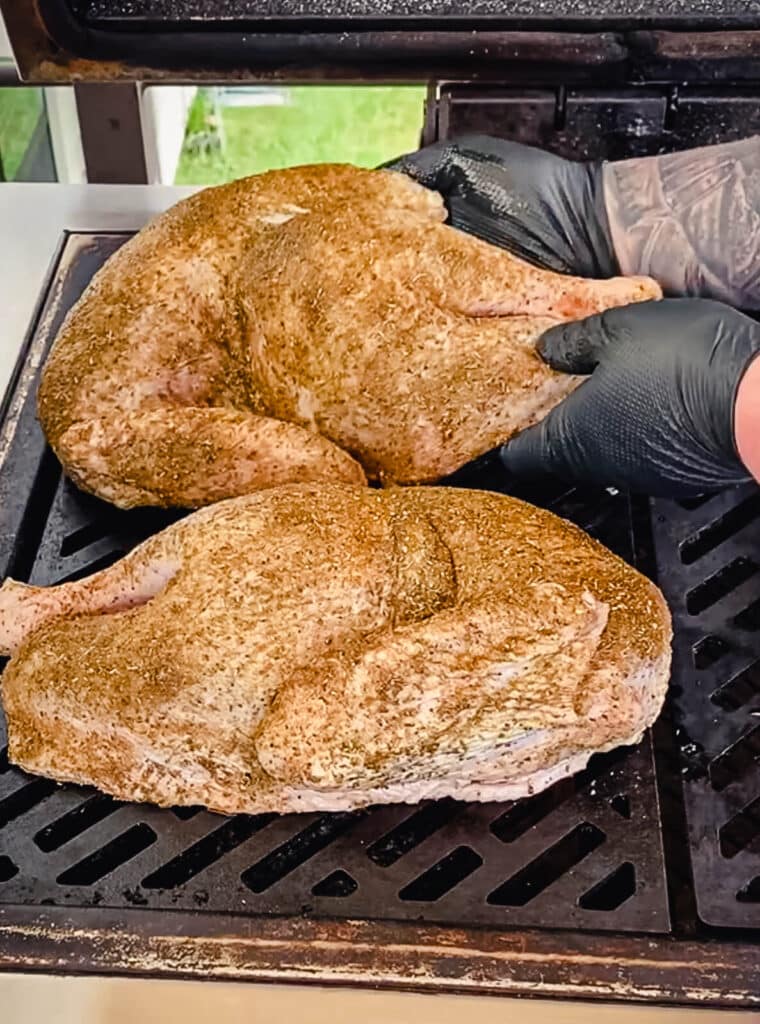placing turkey halves on the grill for a roast turkey recipe