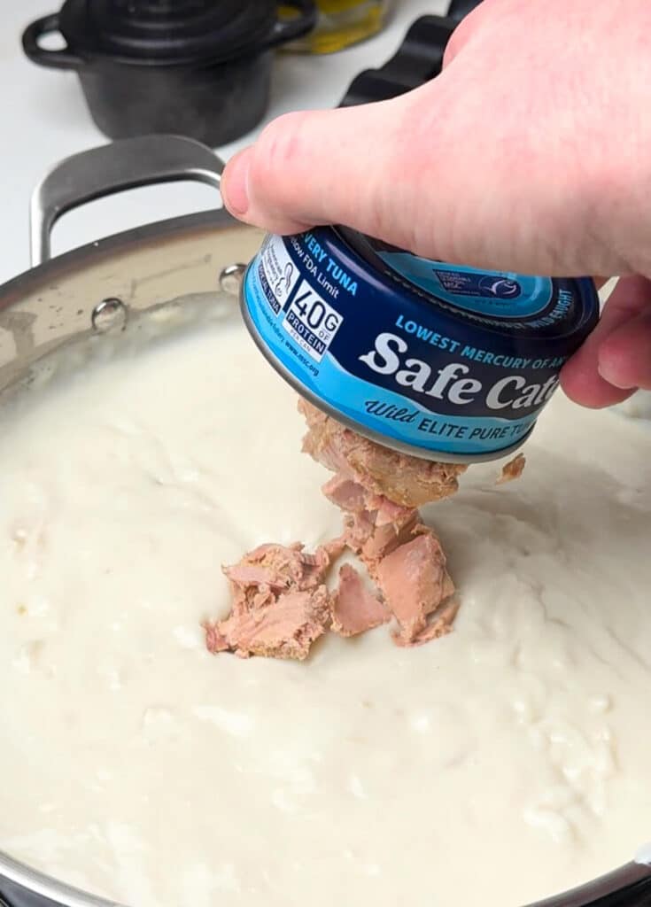 tune being added into a creamed tuna recipe