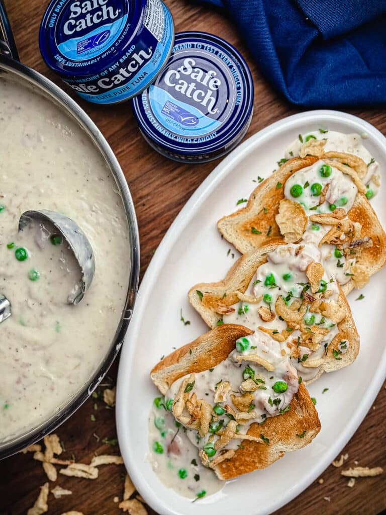 creamed tuna on toast with peas and pan of sauce