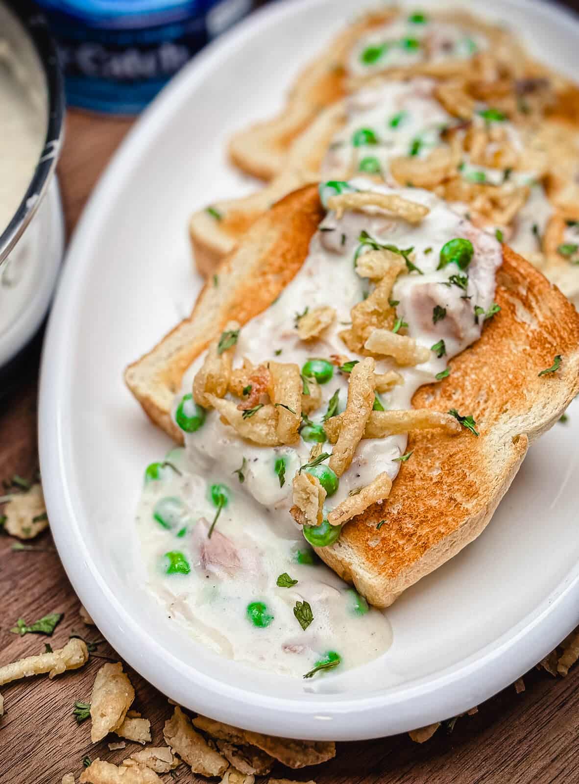 creamed tuna on toast with fried onions and peas