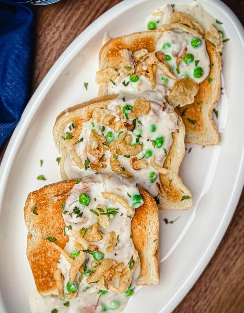 creamed tuna on toast served on a white platter