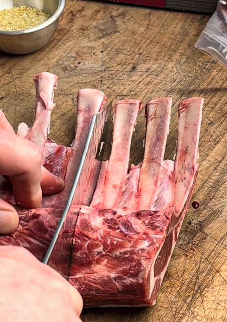 cutting a rack of lamb into lamb rib chops