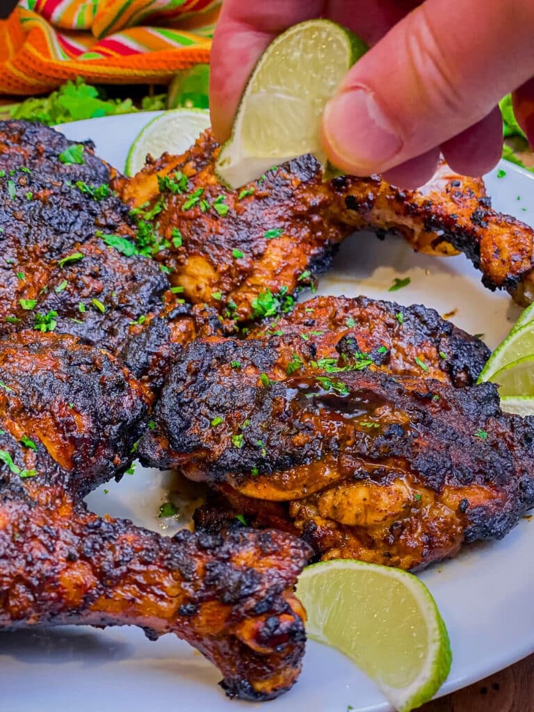 lime being squeezed over pollo asado