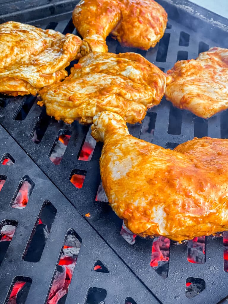 raw chicken placed on a hot grill.