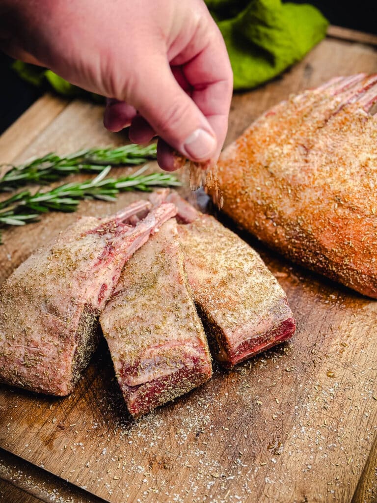 seasoning a rack of lamb with rosemary salt 