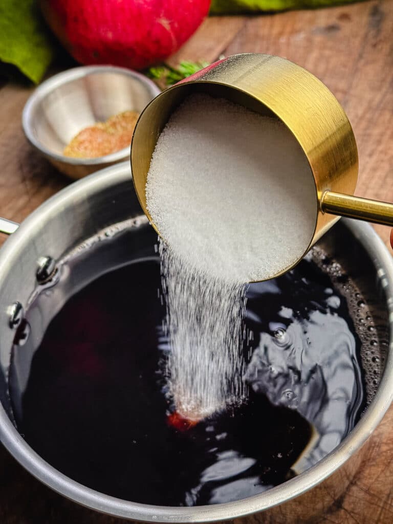 sugar being added to pomegranate glaze
