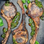 platter with grilled tomahawk pork chops and chimichurri sauce