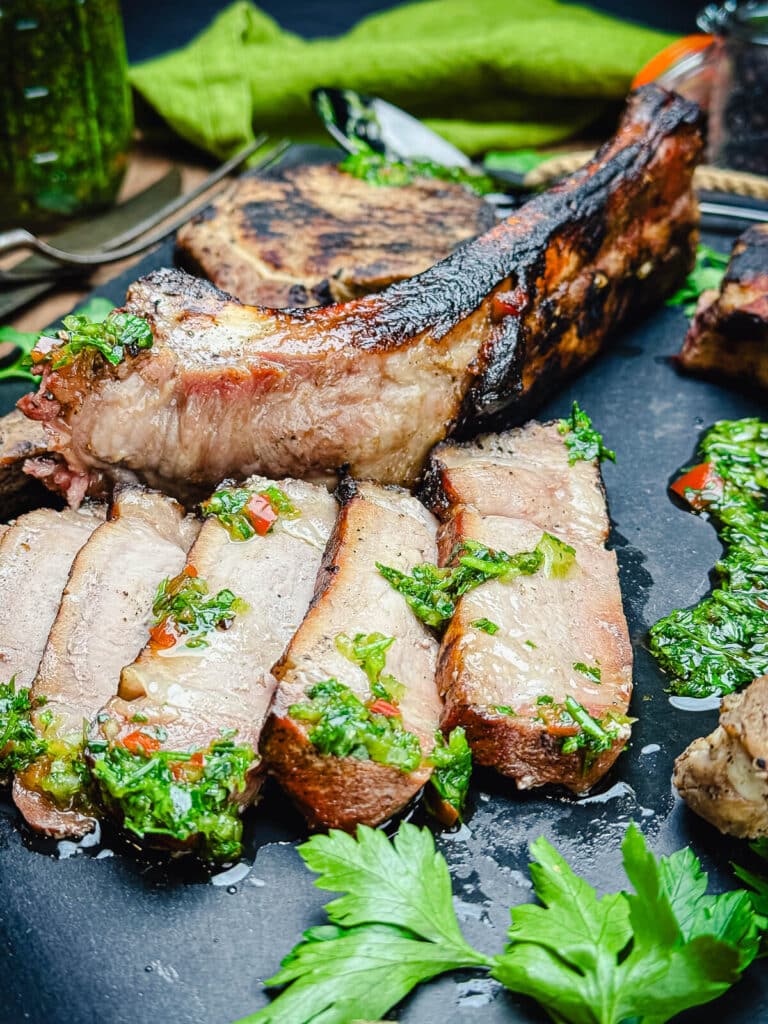 sliced pork chop with the bone in the background