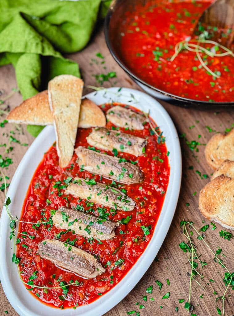 sardines in a spicy red sauce on a platter