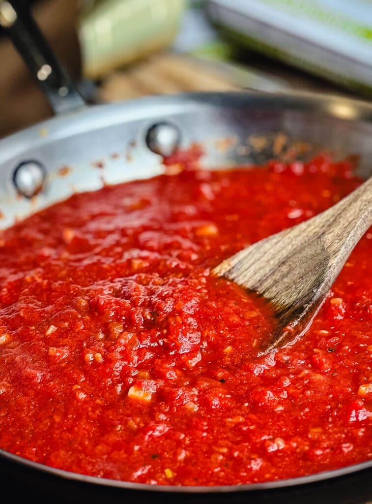 red sauce cooking in stainless steel skillet