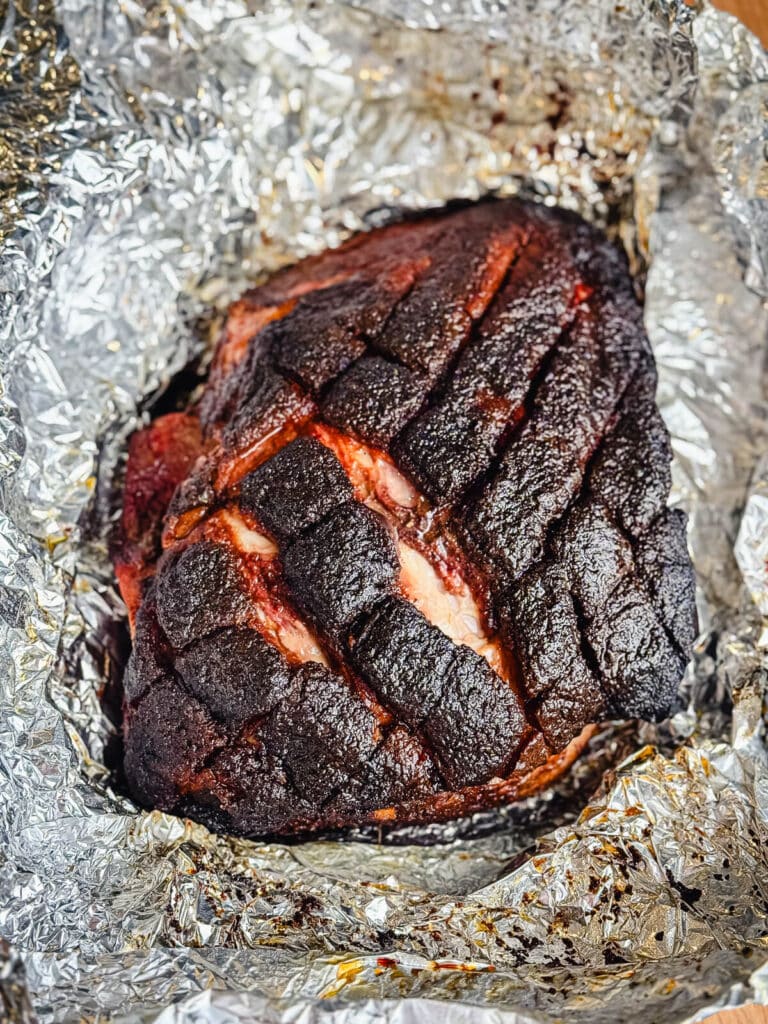Smoked pork shoulder on aluminum foil
