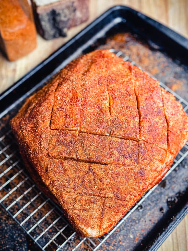 seasoned pork shoulder on a cooling rack