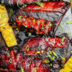 huli huli ribs on a platter with grilled pineapple