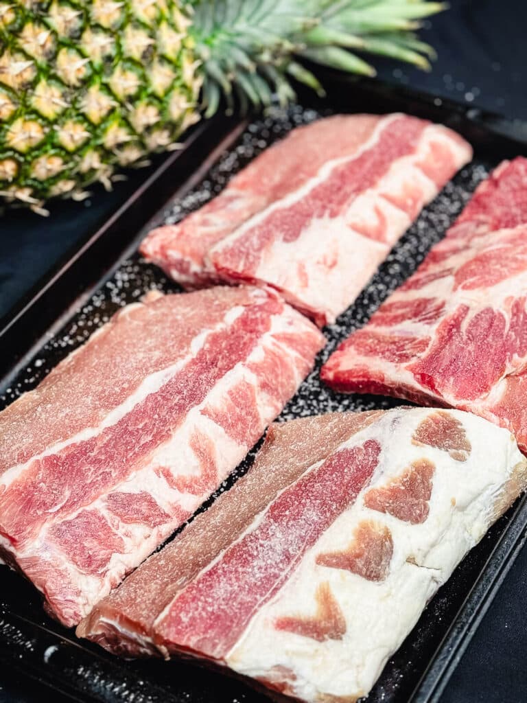 baby back ribs seasoned with salt on a try
