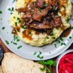 slow cooker beef tips over top of mashed potatoes