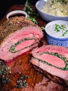 stuffed prime rib sliced on a cutting board