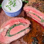 stuffed prime rib sliced on a cutting board