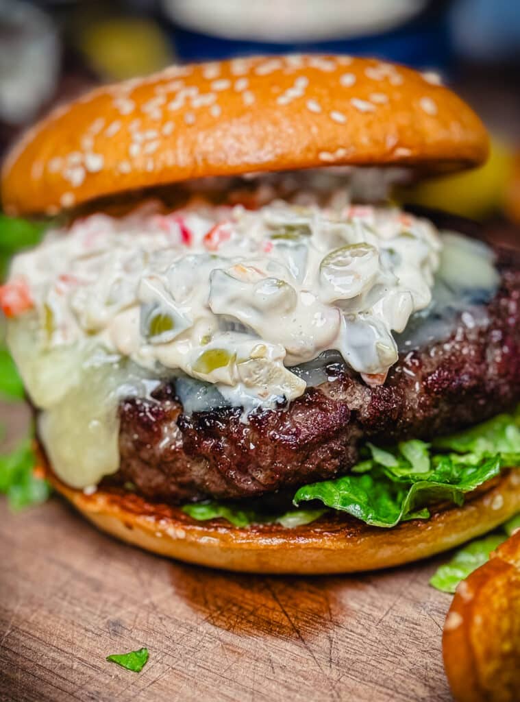 close up of a Michigan olive burger on a cutting board with melted cheese