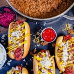 coney island hot dog sauce with hot dogs in the foreground