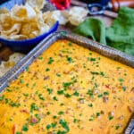 smoked queso dip in a large aluminum pan
