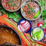borracho beans in two bowls with radishes and limes
