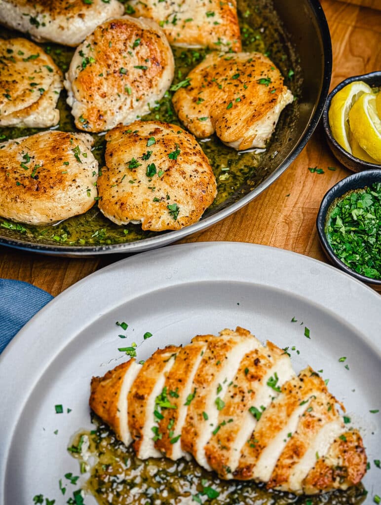 chicken pan sauce with seared chicken breast on a gray plate