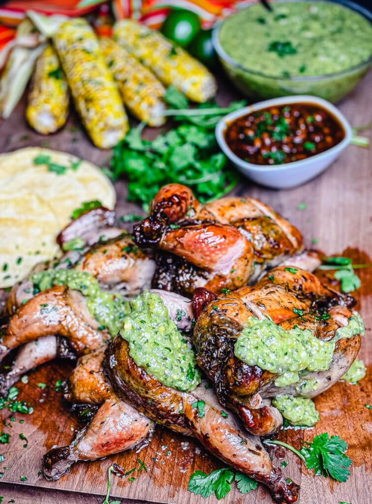 Cornish hens cut into pieces with a green sauce on them