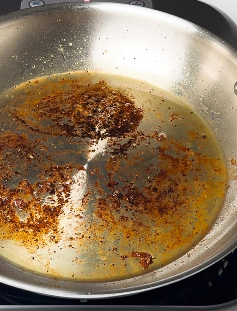 stainless steel pan with fond in the bottom