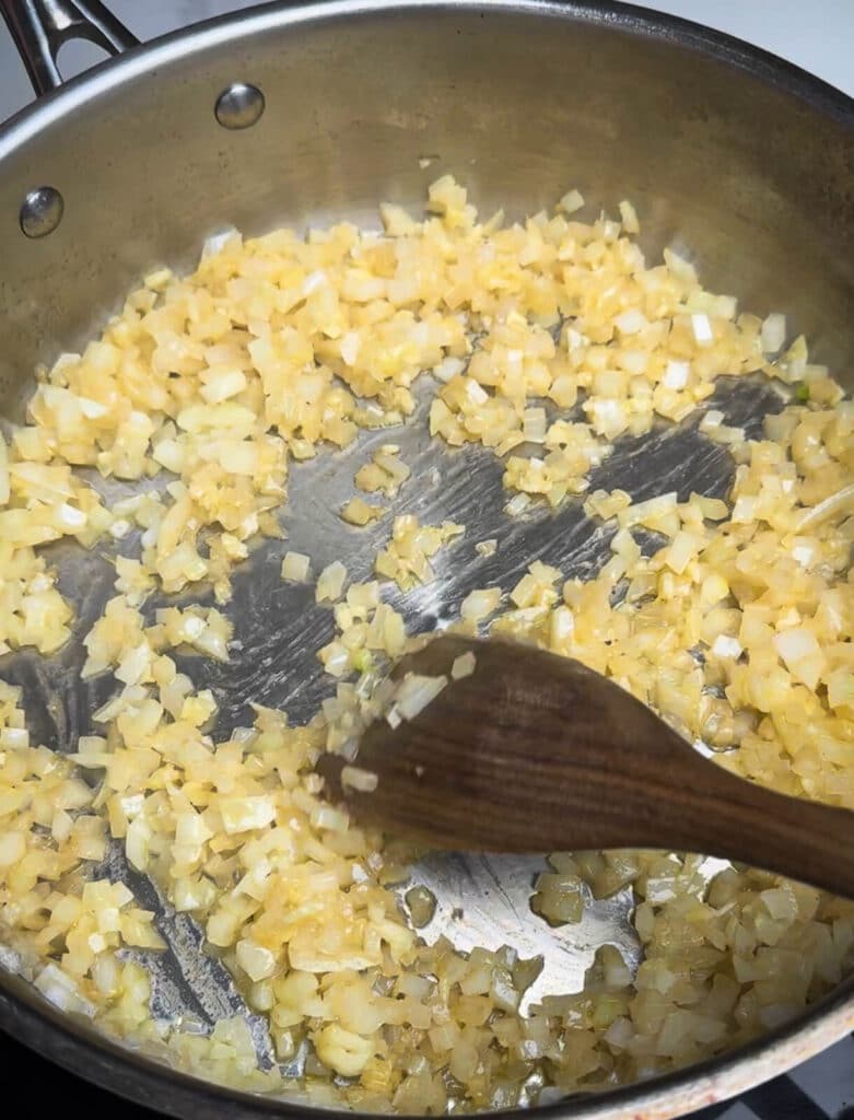 onions being sweated down in a pan with butter