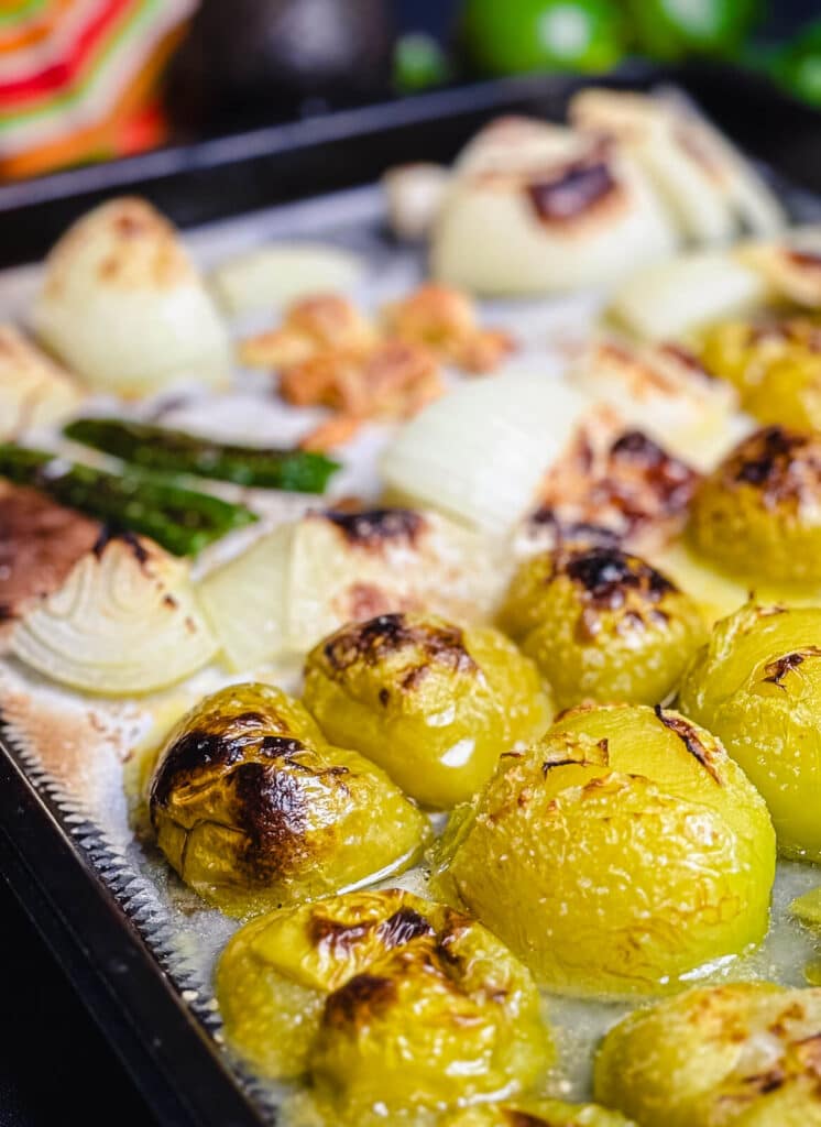roasted tomatillos on a baking sheet