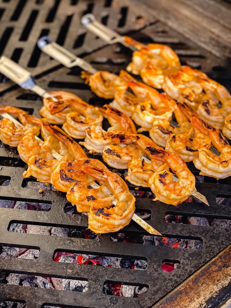 skewered shrimp on the grill over hot coals
