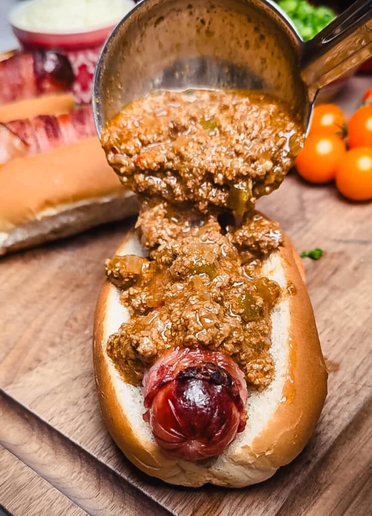 chili being added to a taco dog