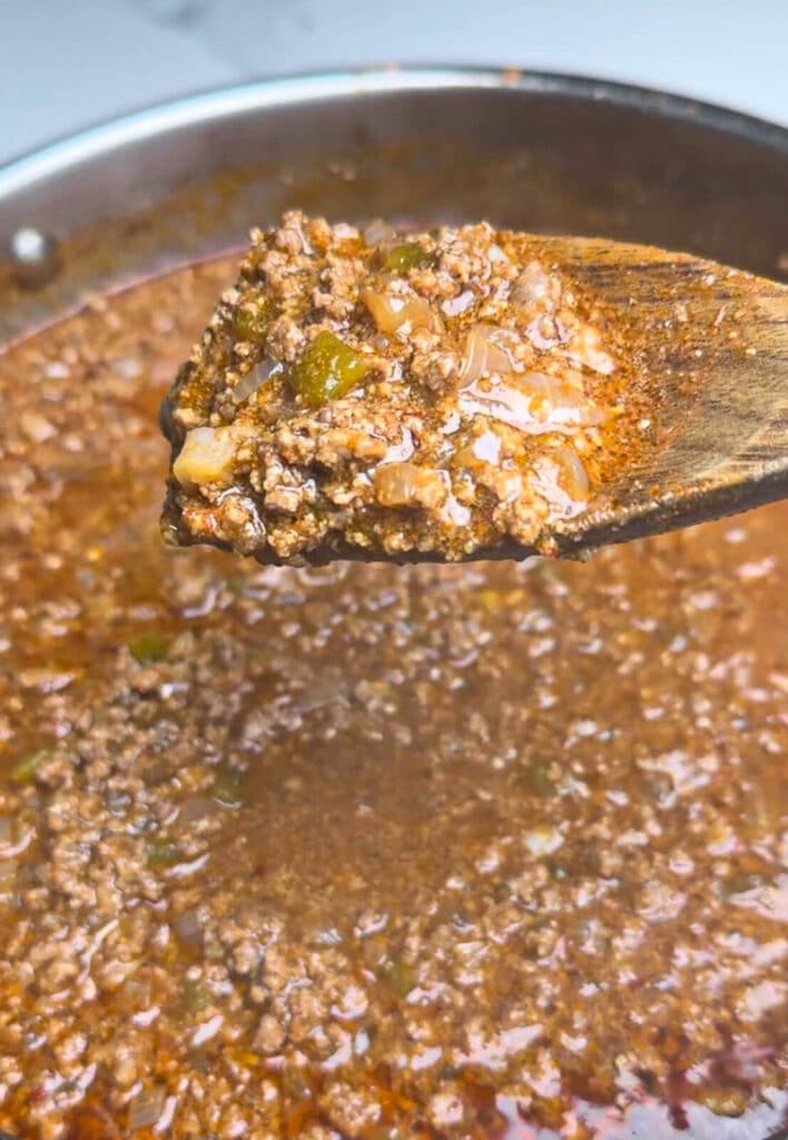 chili for taco dogs on a spoon