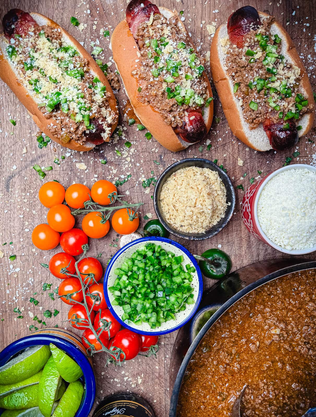 taco dogs on a platter with tomatoes and chili