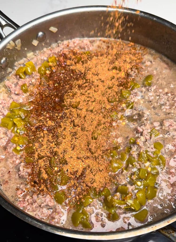 taco seasoning being added to taco chili
