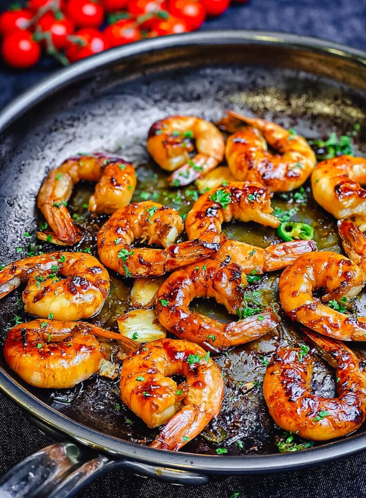 shrimp searing in a stainless steel pan