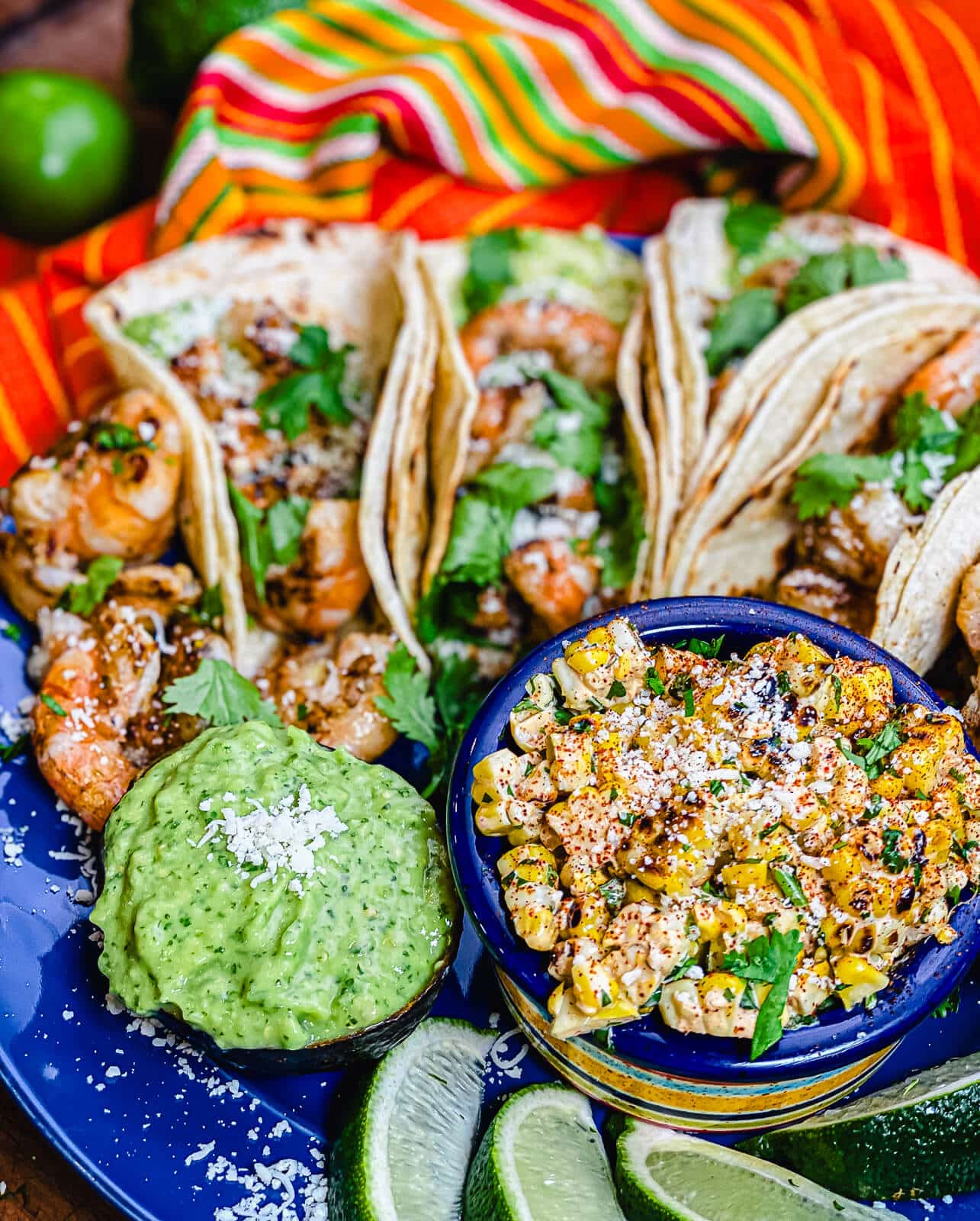 tequila lime shrimp tacos on a platter with an orange towel in the background