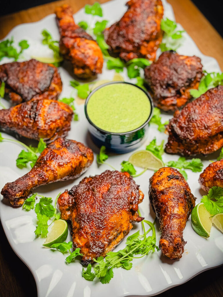 platter of peruvian grilled chicken with green sauce