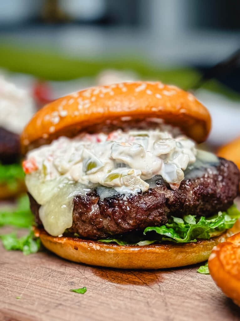 Michigan olive burger with lettuce on a wooden platter
