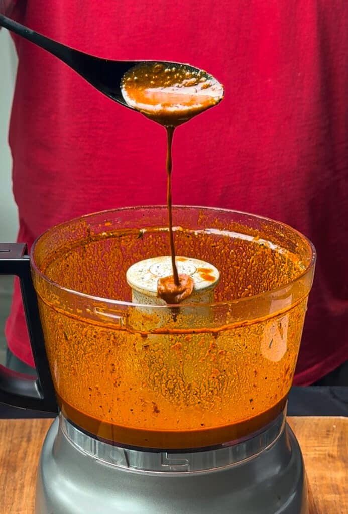 Peruvian chicken marinade dripping from a spoon