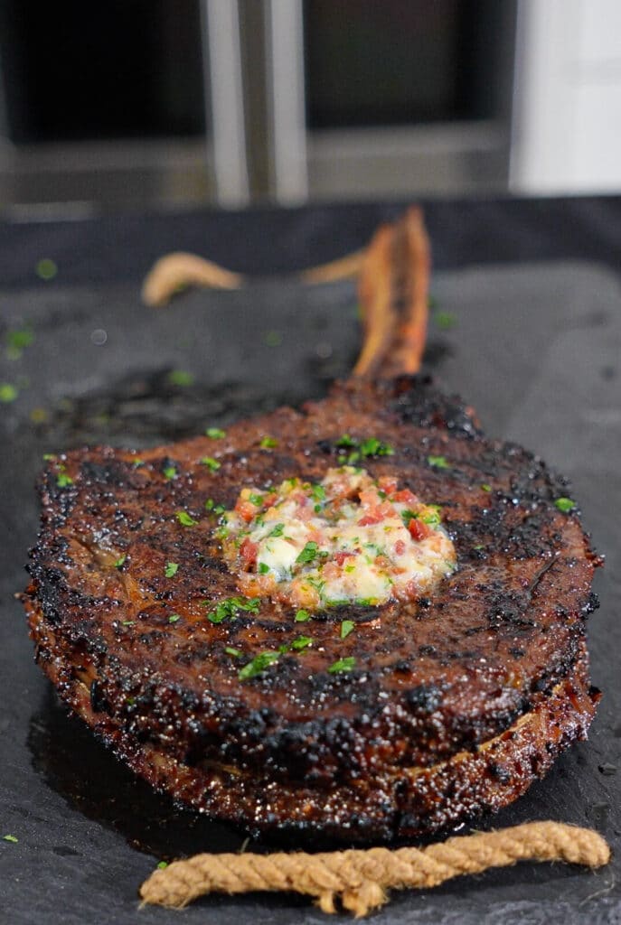 tomahawk steak with compound butter and bacon